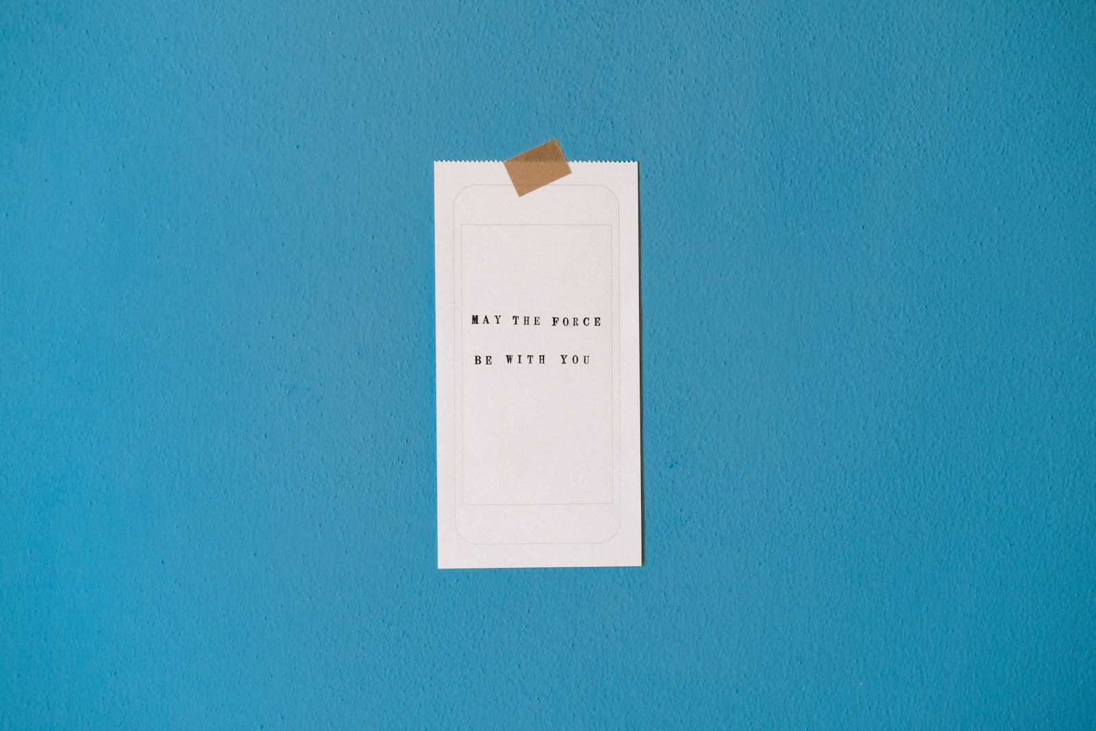 white printer paper on teal wall